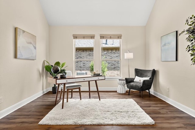 office area with baseboards, vaulted ceiling, and dark wood-type flooring