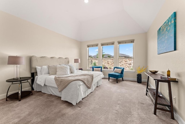 carpeted bedroom with lofted ceiling and baseboards