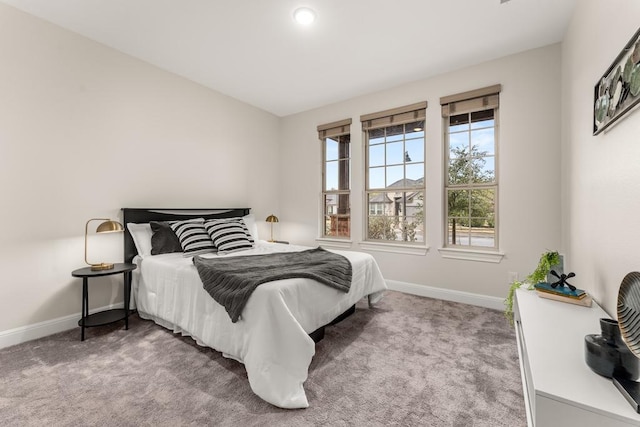 bedroom featuring carpet floors and baseboards