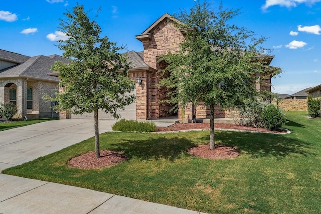 view of front of home with a garage, concrete driveway, brick siding, and a front lawn