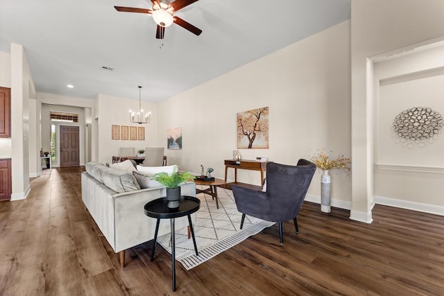 living area with wood finished floors, visible vents, and baseboards