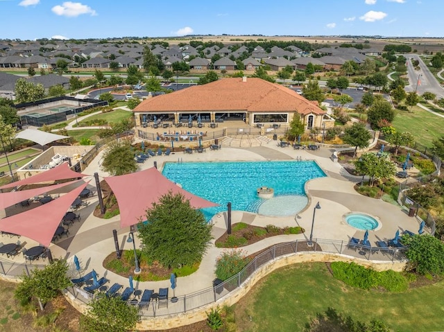 pool featuring a patio area, fence, and a residential view