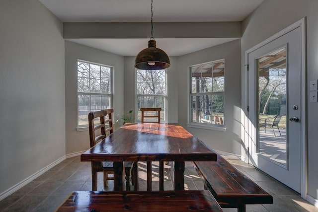 dining space featuring baseboards and tile patterned floors