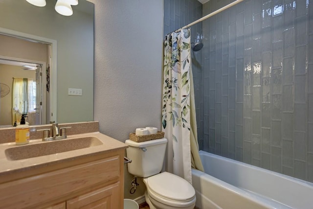 bathroom with vanity, shower / bath combo with shower curtain, and toilet