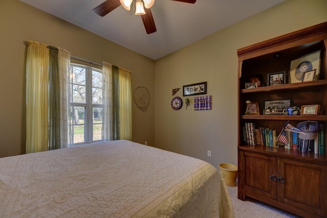 bedroom with light carpet and a ceiling fan