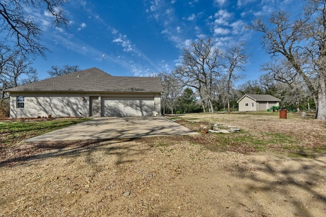 view of home's exterior with an attached garage and concrete driveway