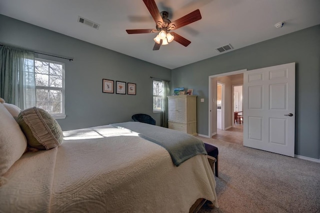 bedroom with light carpet, baseboards, visible vents, and a ceiling fan