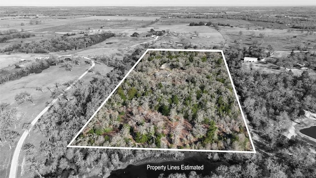 birds eye view of property featuring a rural view