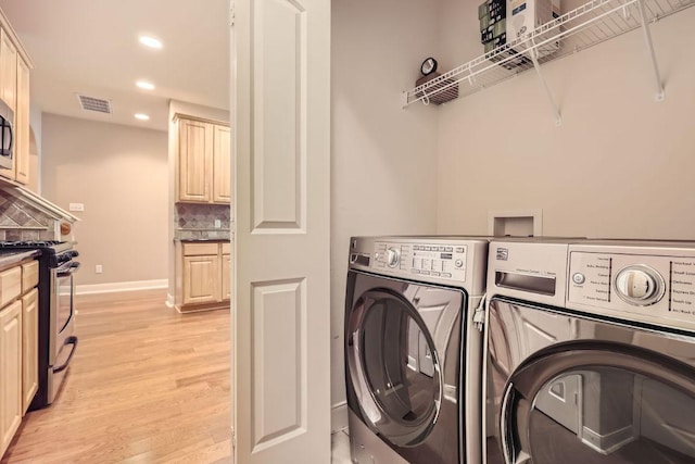 washroom with washing machine and dryer, recessed lighting, laundry area, visible vents, and light wood-type flooring