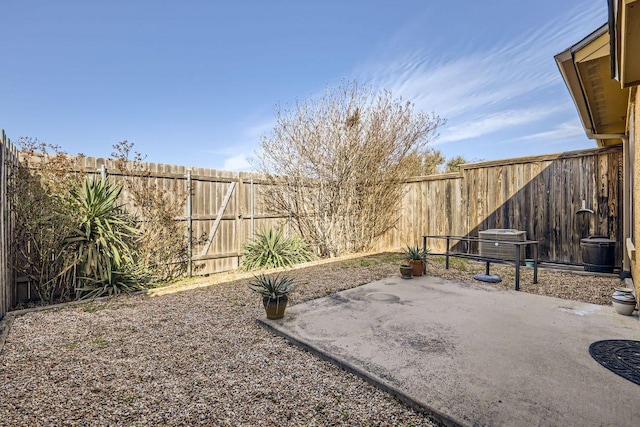 view of yard featuring a fenced backyard, central AC, and a patio