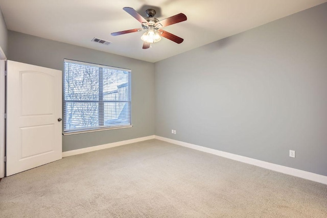 spare room with a ceiling fan, baseboards, visible vents, and carpet flooring