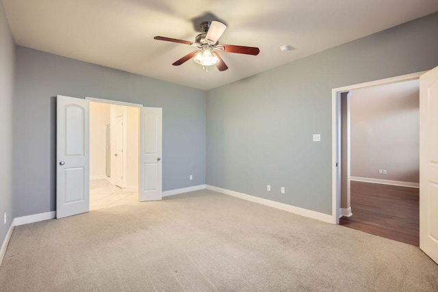 unfurnished bedroom featuring carpet floors, ceiling fan, and baseboards