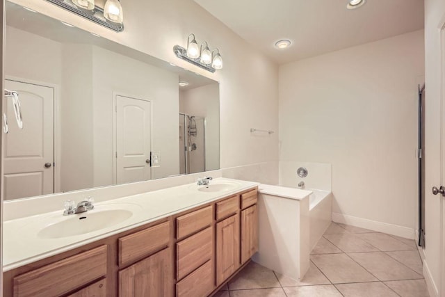 full bathroom with double vanity, tile patterned flooring, a sink, and a bath