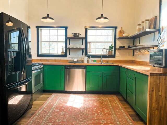 401 San Jacinto St, Smithville, TX 78957 - kitchen featuring butcher block countertops, open shelves, appliances with stainless steel finishes, and a sink
