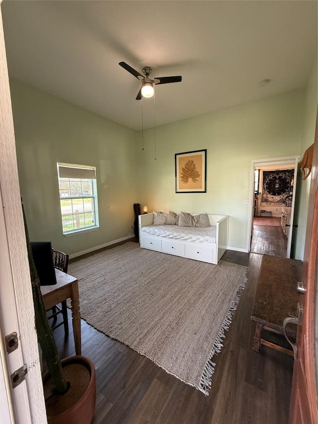 401 San Jacinto St, Smithville, TX 78957 - bedroom with ceiling fan, baseboards, and dark wood-style flooring