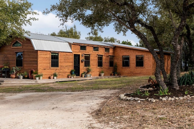 cabin featuring metal roof