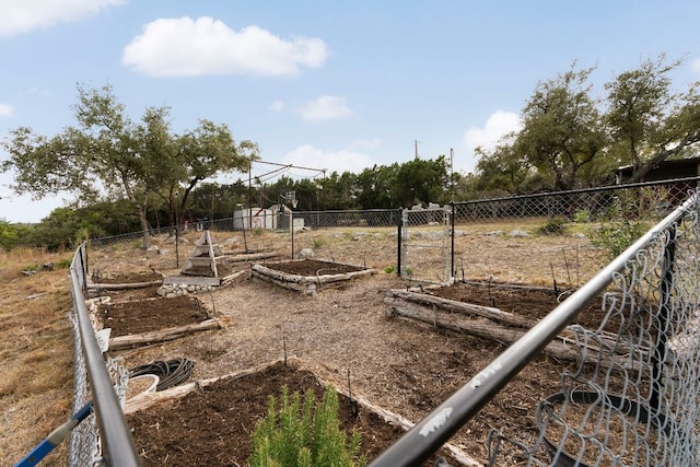 view of yard with fence and a garden