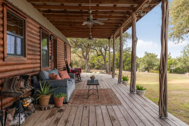 wooden terrace featuring an outdoor hangout area, ceiling fan, and a lawn