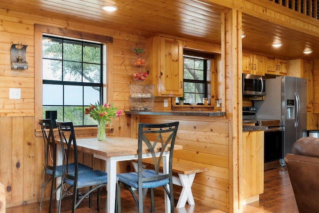 dining space featuring dark wood-style flooring, wood walls, wood ceiling, and recessed lighting