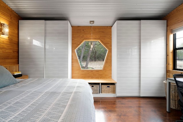 bedroom featuring wood walls and hardwood / wood-style flooring