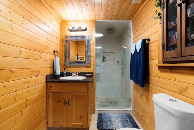 bathroom featuring toilet, wooden walls, a shower stall, vanity, and wooden ceiling