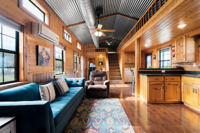 living area featuring lofted ceiling, wood walls, stairway, hardwood / wood-style floors, and a wall mounted air conditioner