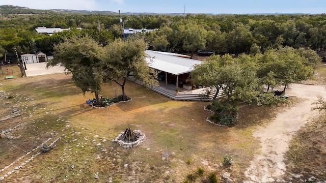 birds eye view of property with a forest view