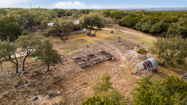 bird's eye view featuring a view of trees and a rural view