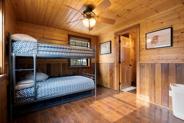 bedroom featuring wood ceiling, wood walls, and hardwood / wood-style flooring