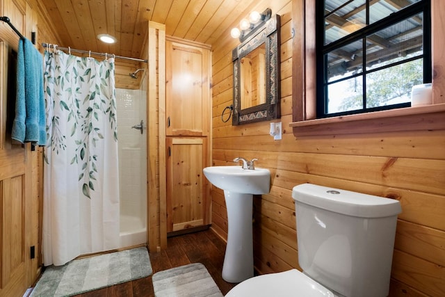 bathroom with toilet, wooden ceiling, a shower stall, and wooden walls