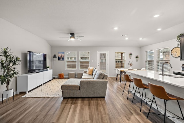 living area with light wood-style floors, recessed lighting, visible vents, and a ceiling fan