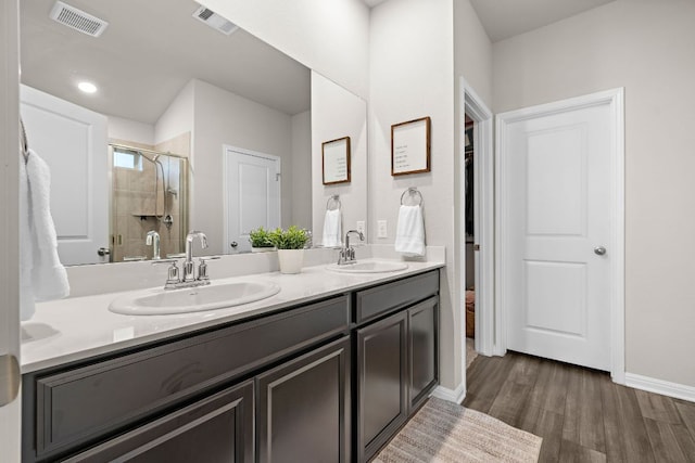 full bath with a stall shower, visible vents, and a sink