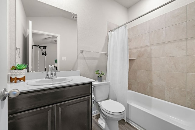 bathroom with shower / bath combination with curtain, wood finished floors, vanity, and toilet