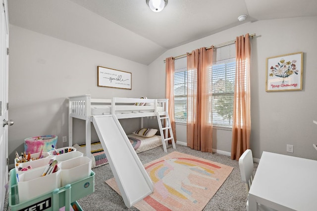 carpeted bedroom featuring baseboards and vaulted ceiling