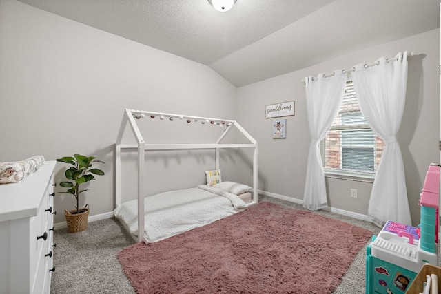 carpeted bedroom with baseboards, vaulted ceiling, and a textured ceiling