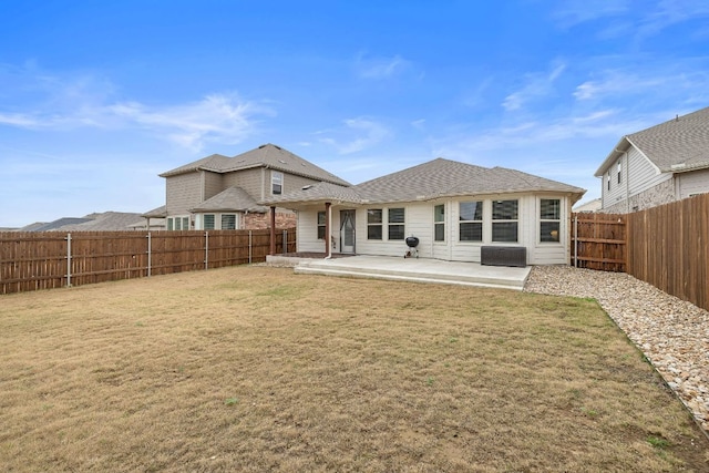 back of house with a lawn, a patio area, and a fenced backyard