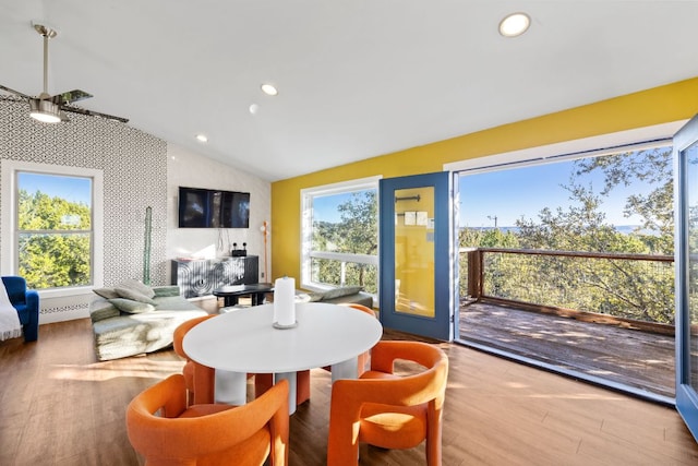 dining space with vaulted ceiling, recessed lighting, wood finished floors, and a healthy amount of sunlight