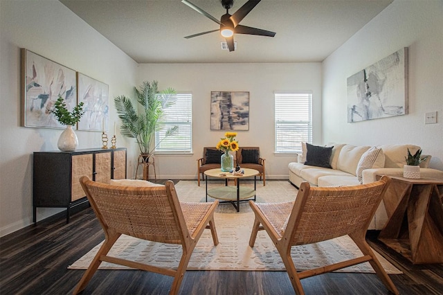 living area with wood finished floors, a wealth of natural light, and baseboards