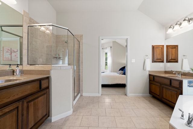 bathroom with lofted ceiling, two vanities, a sink, and a shower stall