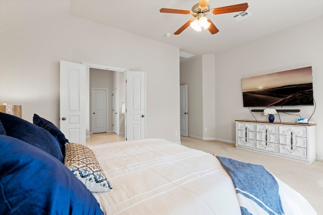 carpeted bedroom with vaulted ceiling, baseboards, visible vents, and a ceiling fan