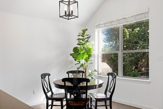 tiled dining room with vaulted ceiling and a notable chandelier