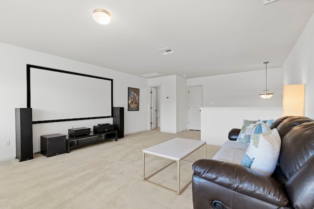 home theater room with light carpet and visible vents