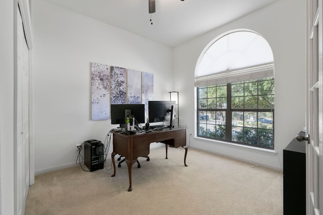 office space with carpet, a ceiling fan, and baseboards