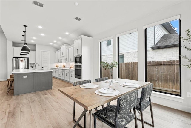 dining area with recessed lighting, visible vents, and light wood-style floors