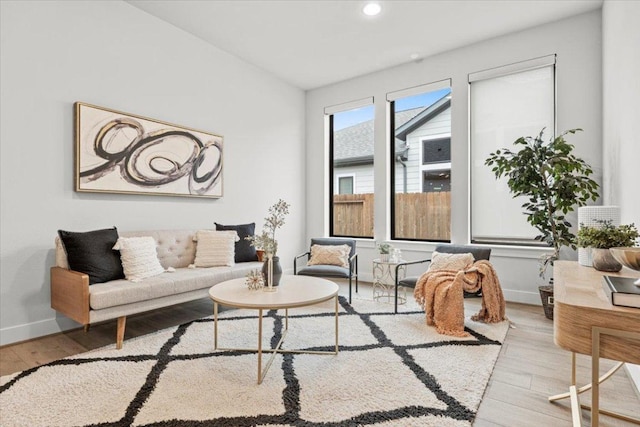 living room with recessed lighting, baseboards, and wood finished floors