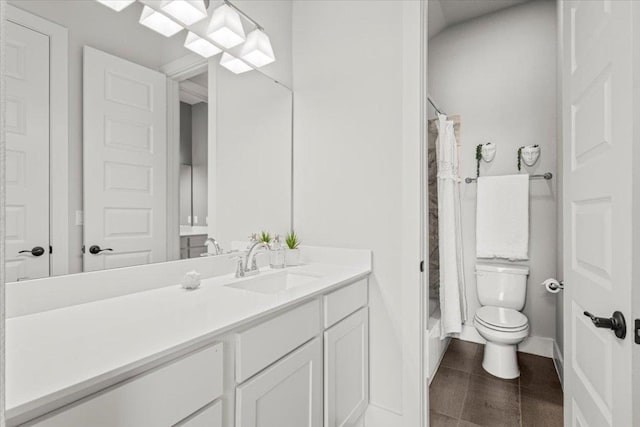 bathroom with tile patterned flooring, vanity, and toilet