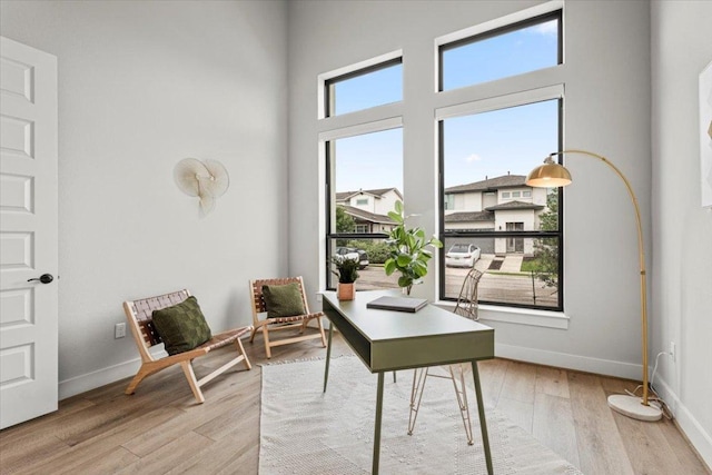 home office with light wood-style floors and baseboards