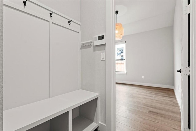 mudroom with light wood finished floors and baseboards