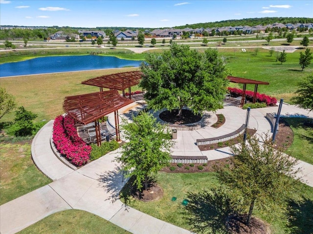 exterior space with a lawn, a water view, and a residential view