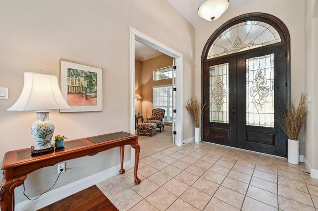 114 Hazelnut Ct, Driftwood, TX 78619 - entryway featuring french doors, baseboards, and light tile patterned floors